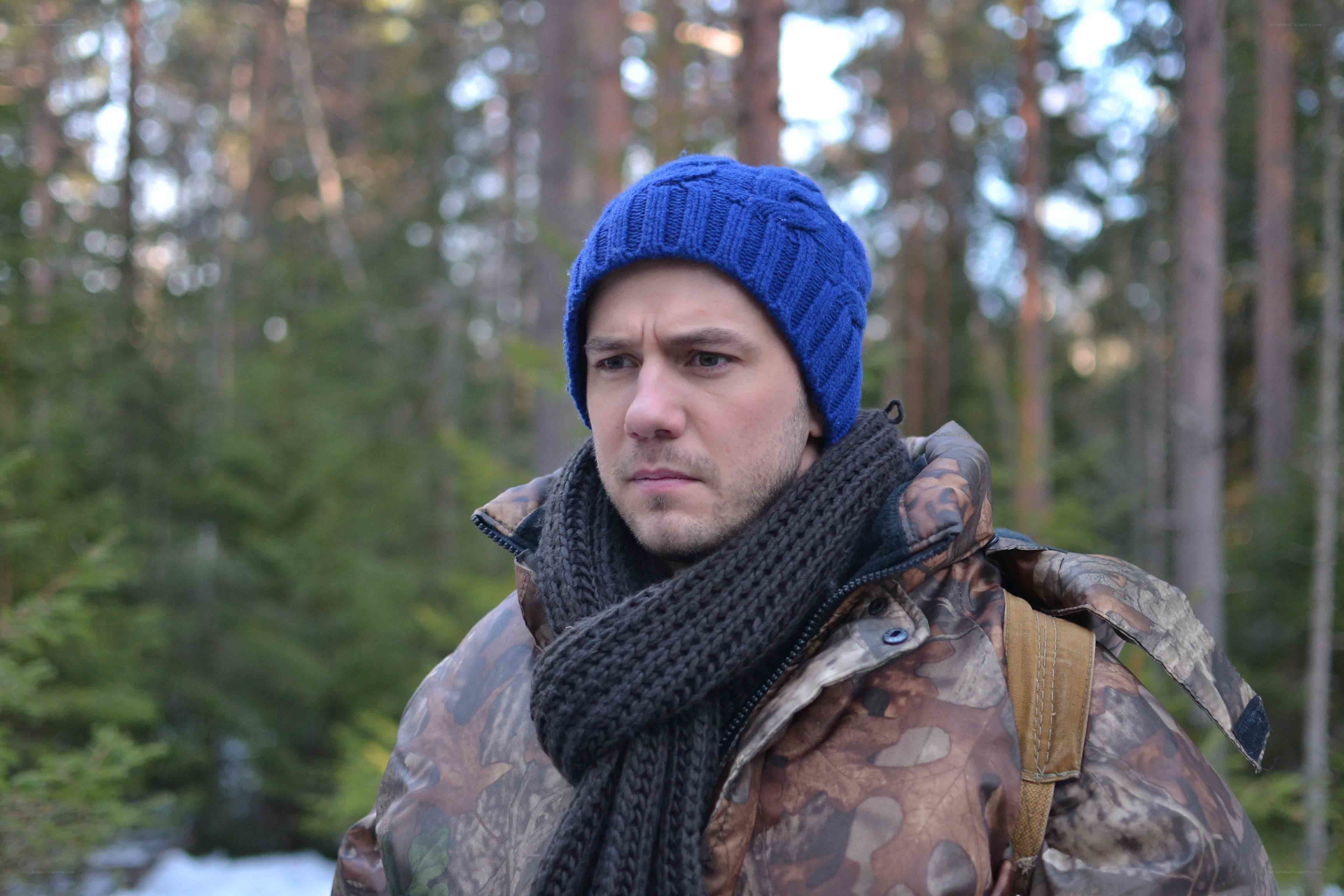 man in forest wearing beanie