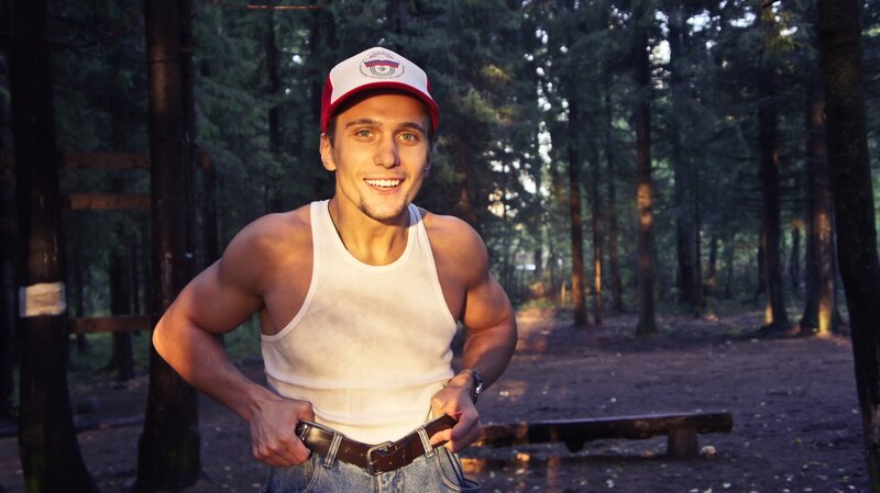 man in forest wearing cap