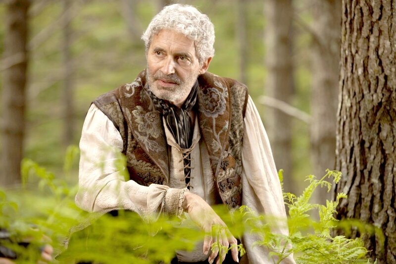 man in forest with curly hair