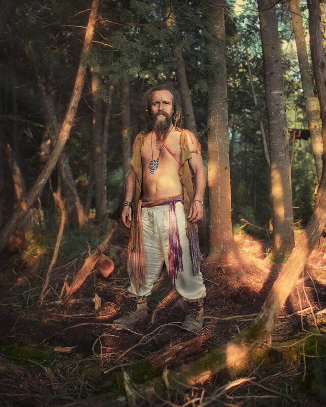 Man in forest with dreadlocks