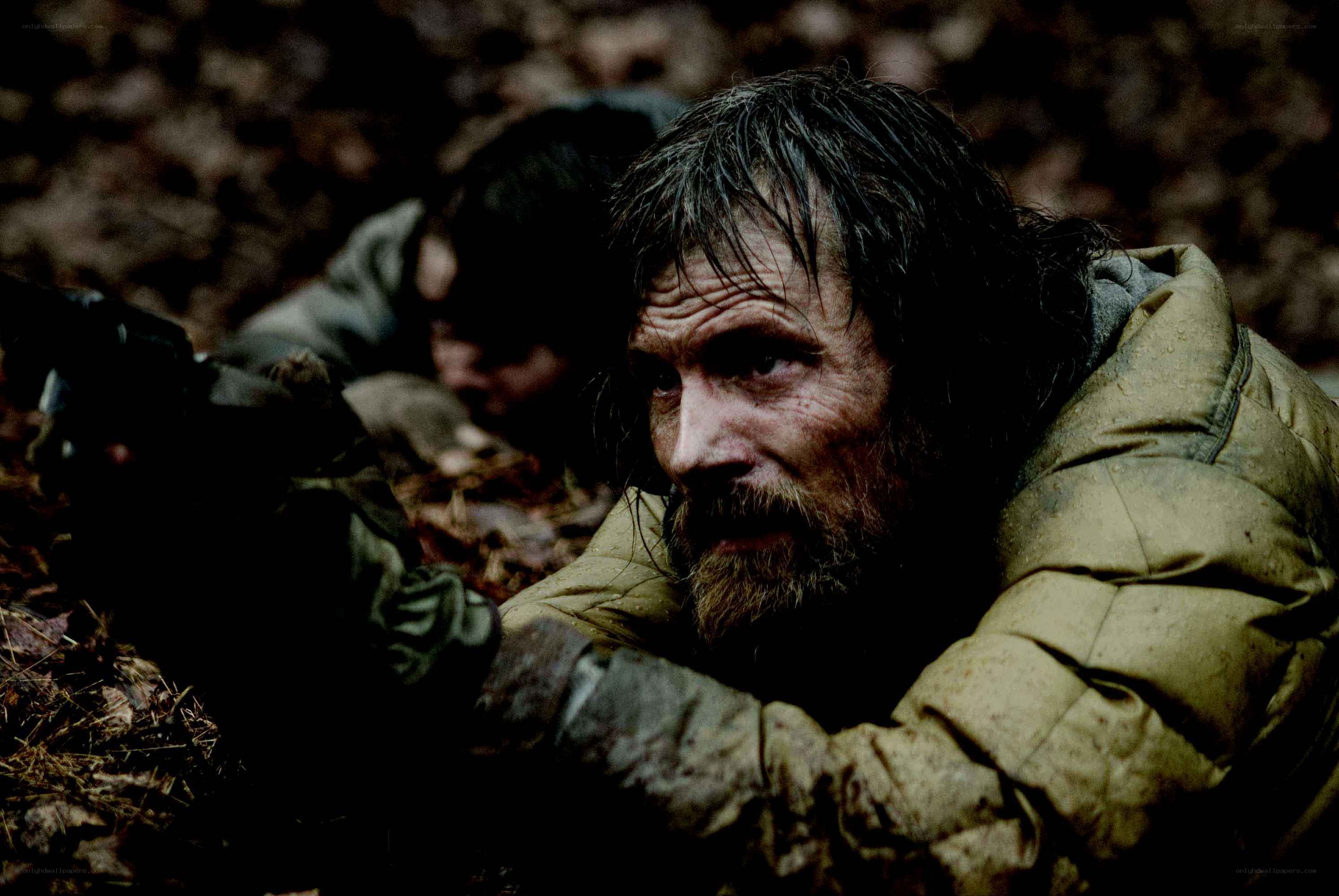 man in forest with rifle