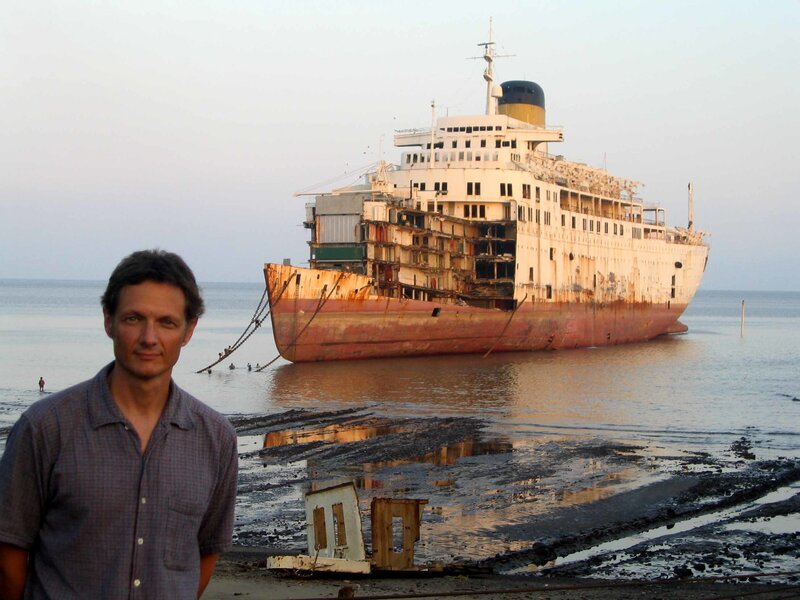 Man in front of a shipwreck