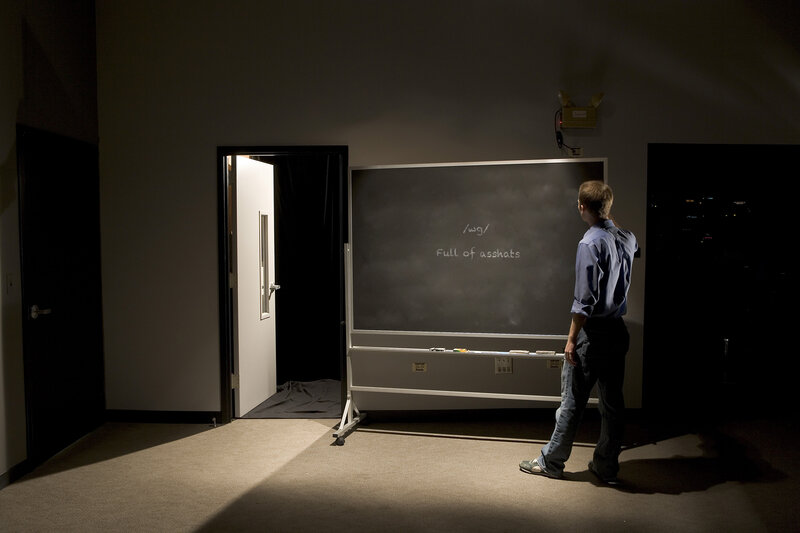 Man in front of chalkboard