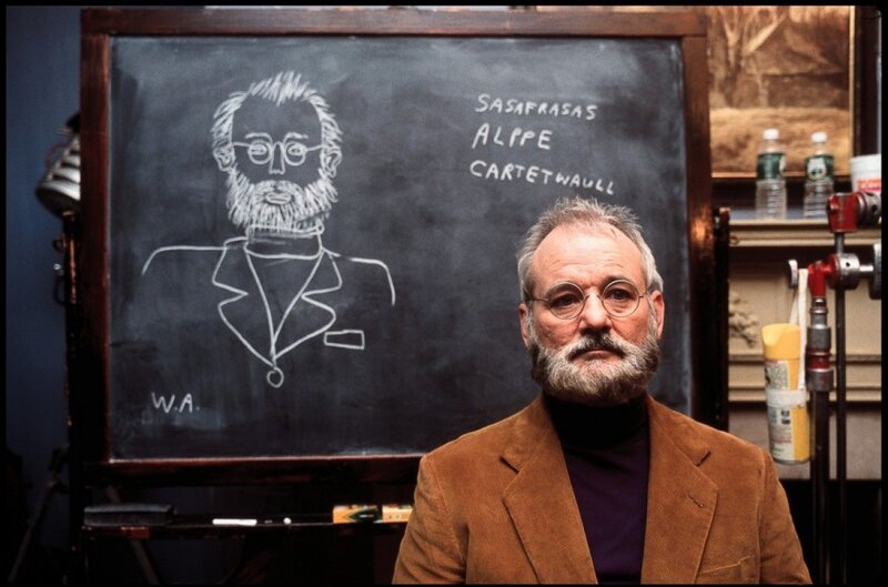 Man in front of chalkboard with drawing
