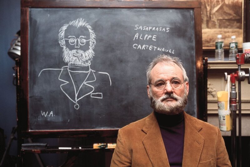 Man in front of chalkboard with drawing