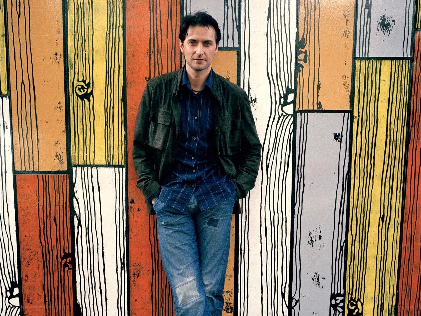 Man in front of colorful wall