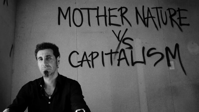 man in front of graffiti