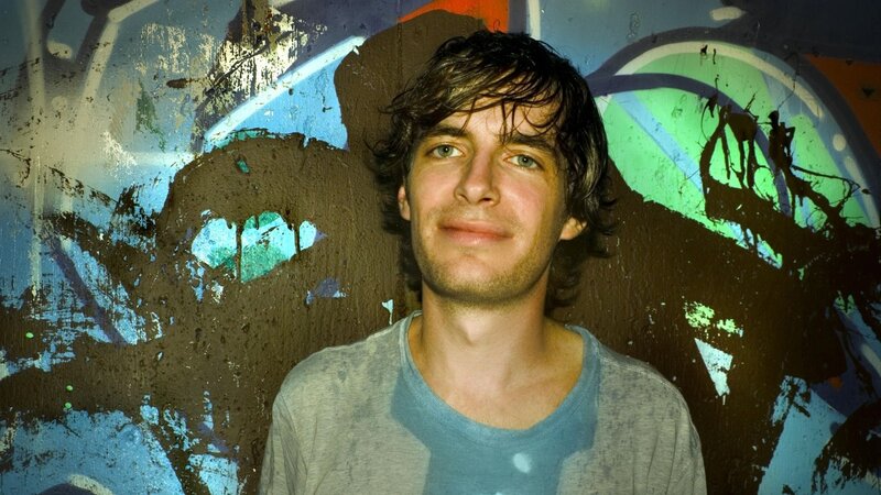 man in front of graffiti wall