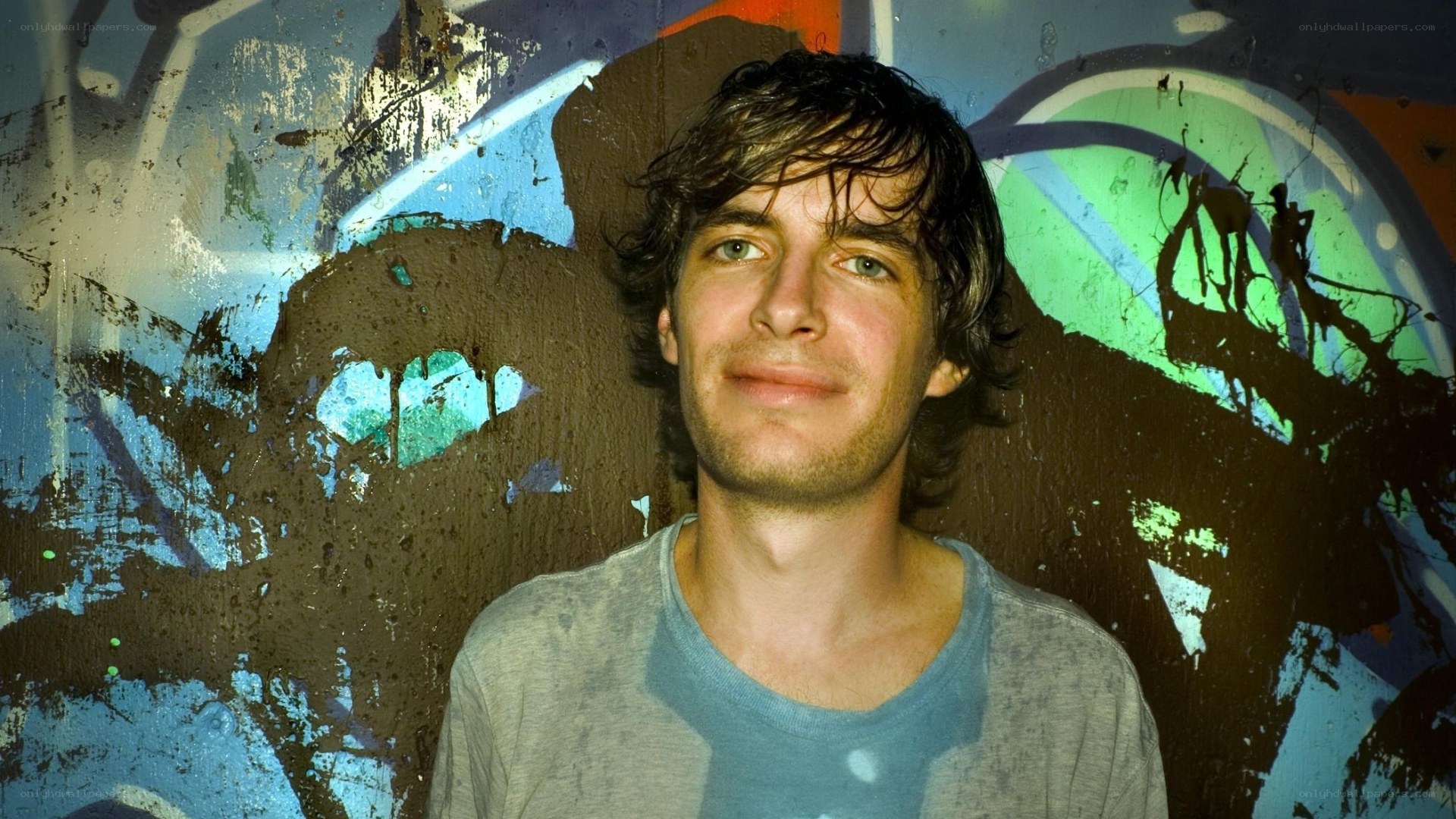 man in front of graffiti wall