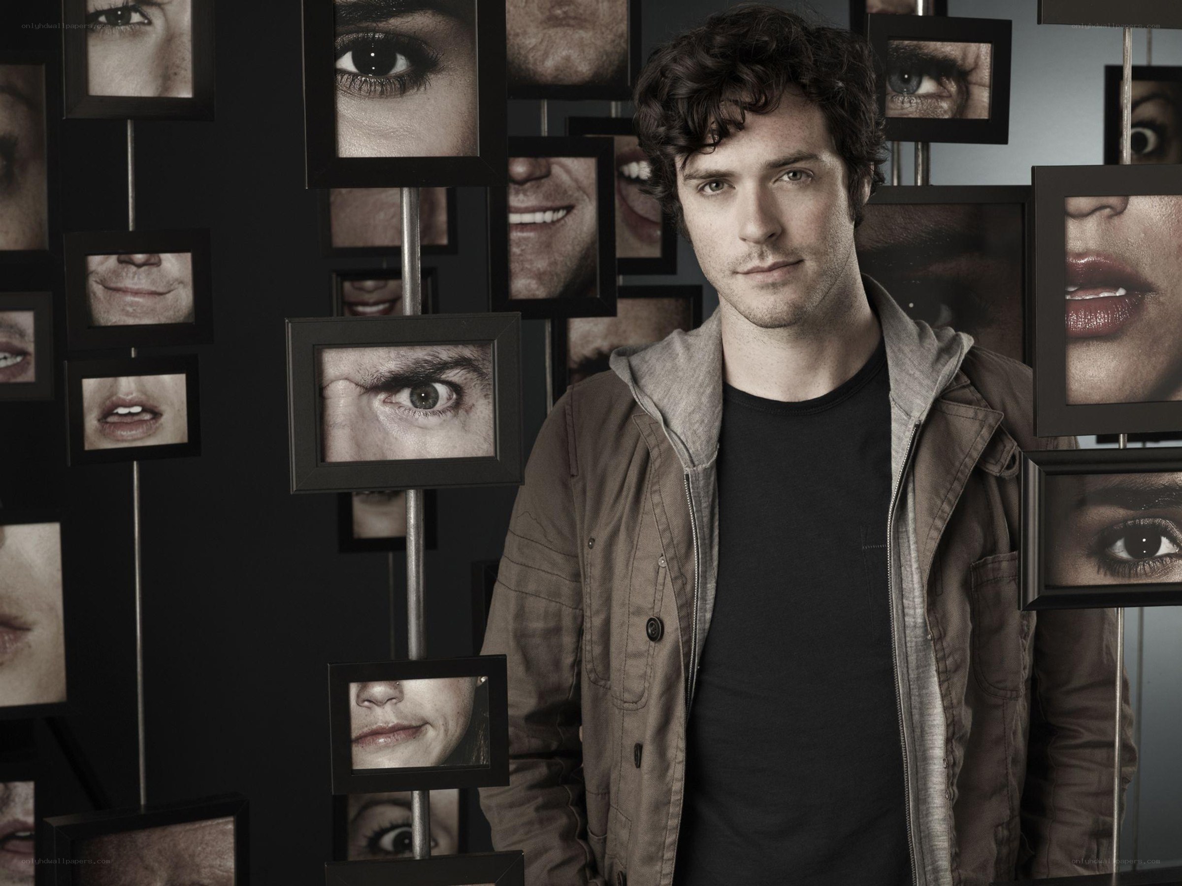 man in front of photo wall