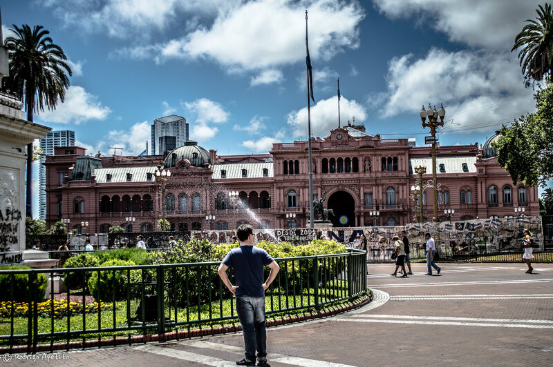 Man in Front of Pink Building