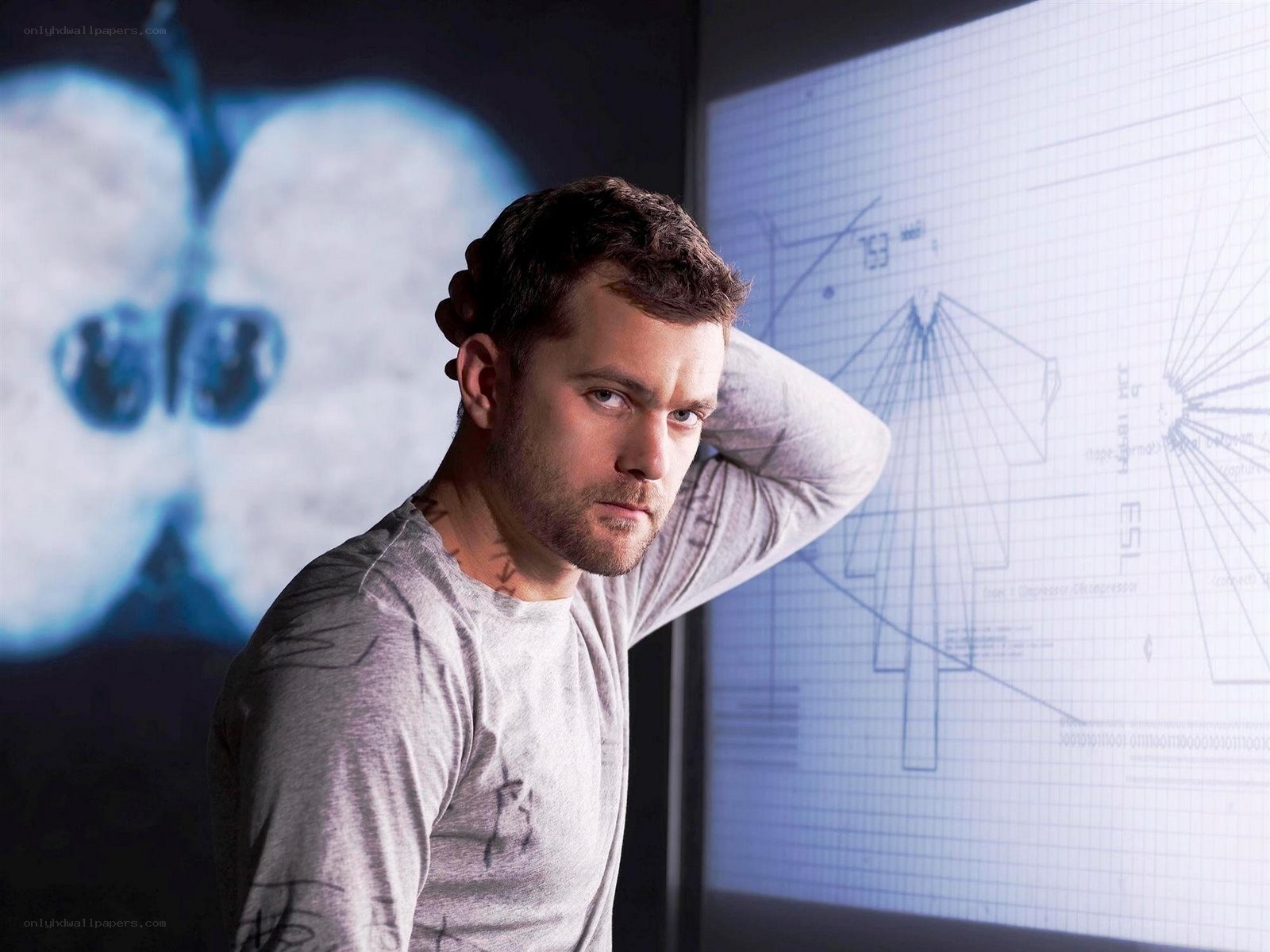 man in front of technical schematics