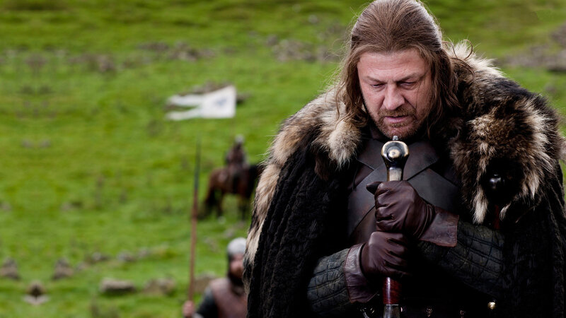 Man in fur cloak holding sword