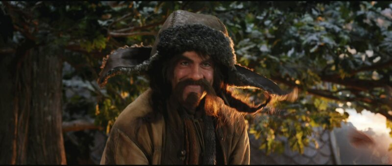 man in fur hat smiling