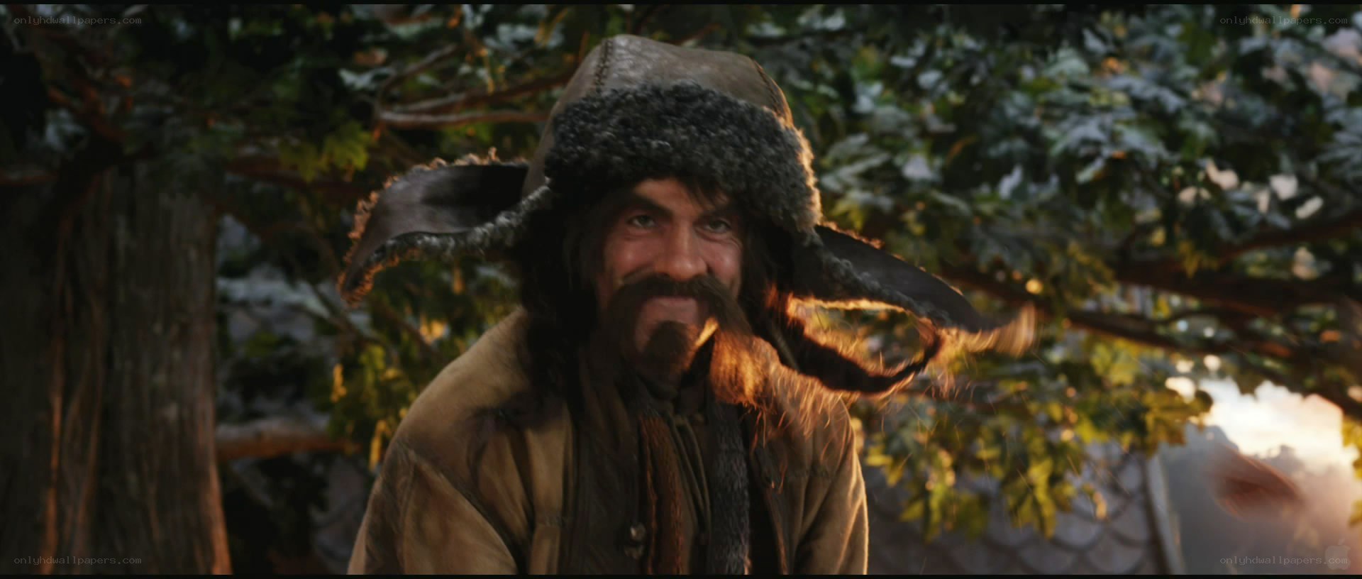 man in fur hat smiling