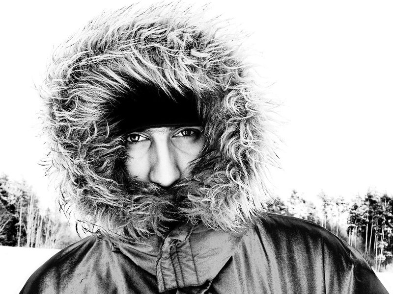 man in fur hood outdoors