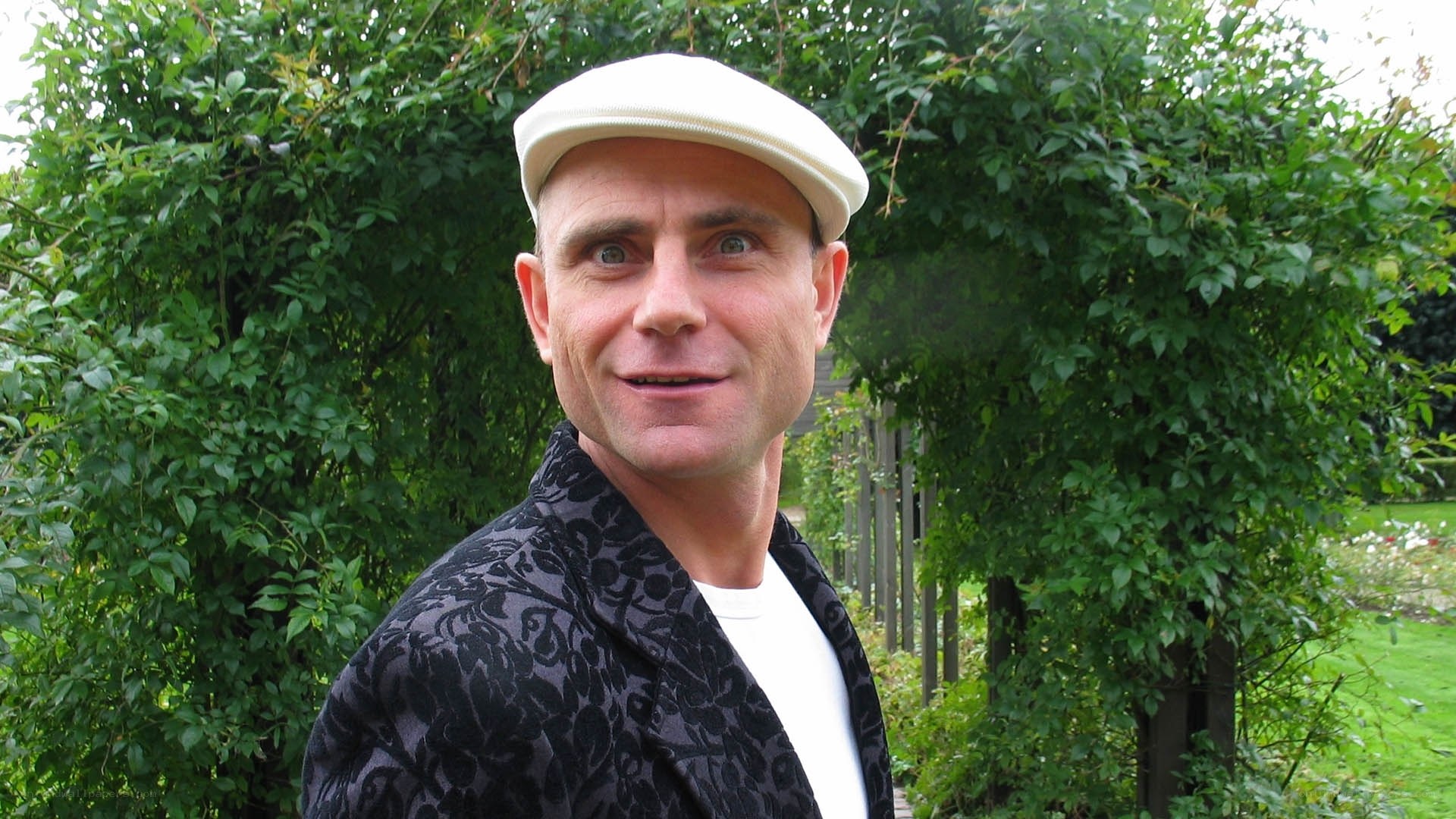 man in garden wearing cap