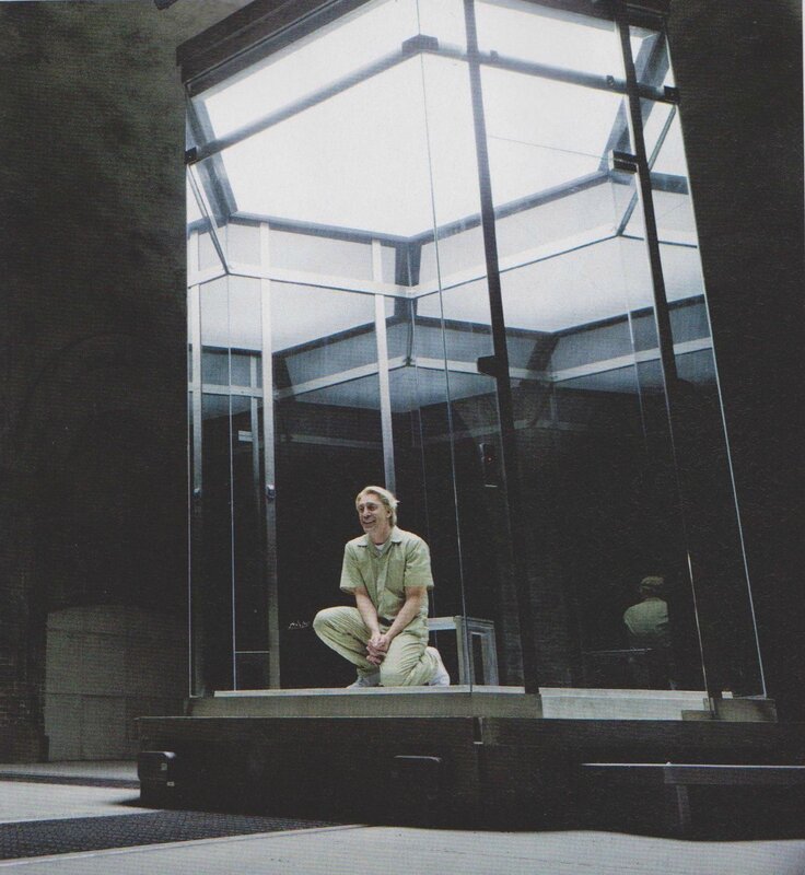 man in glass enclosure