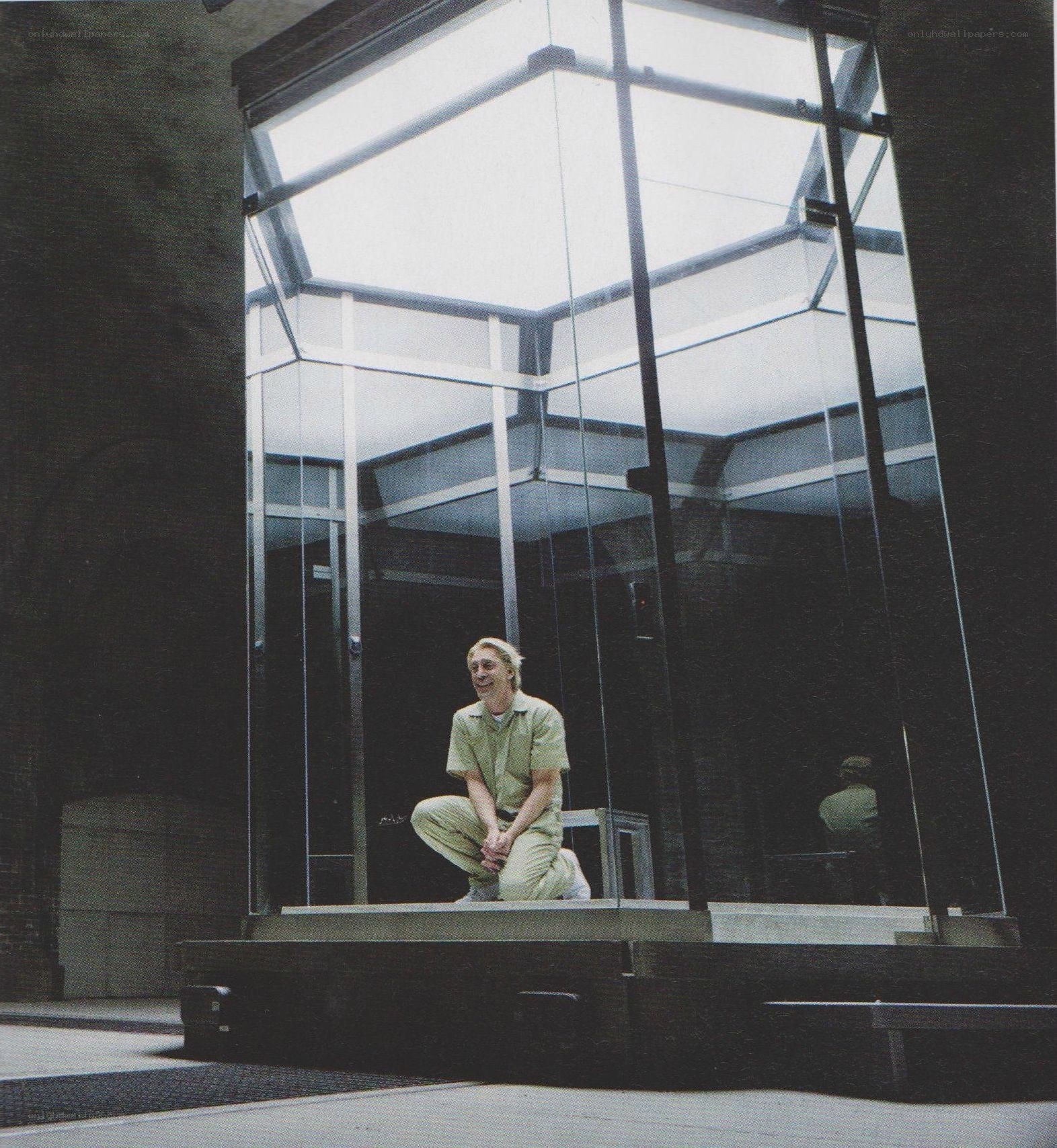 man in glass enclosure