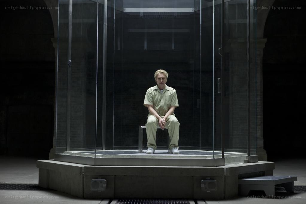 Man in glass prison cell