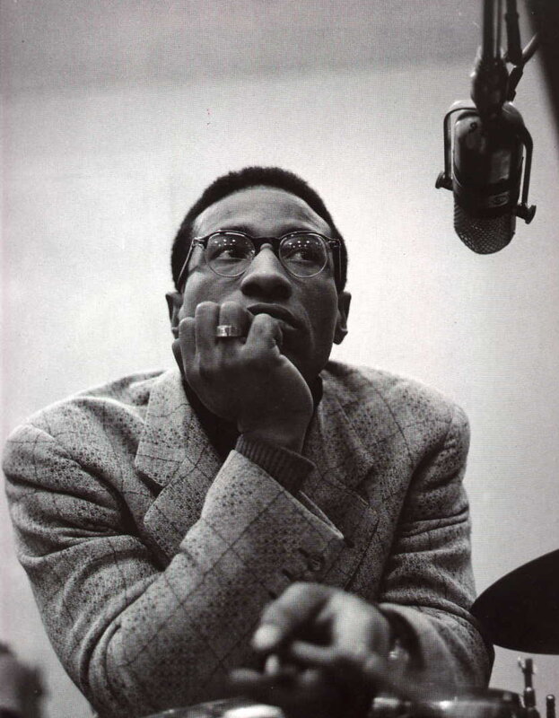 man in glasses at microphone