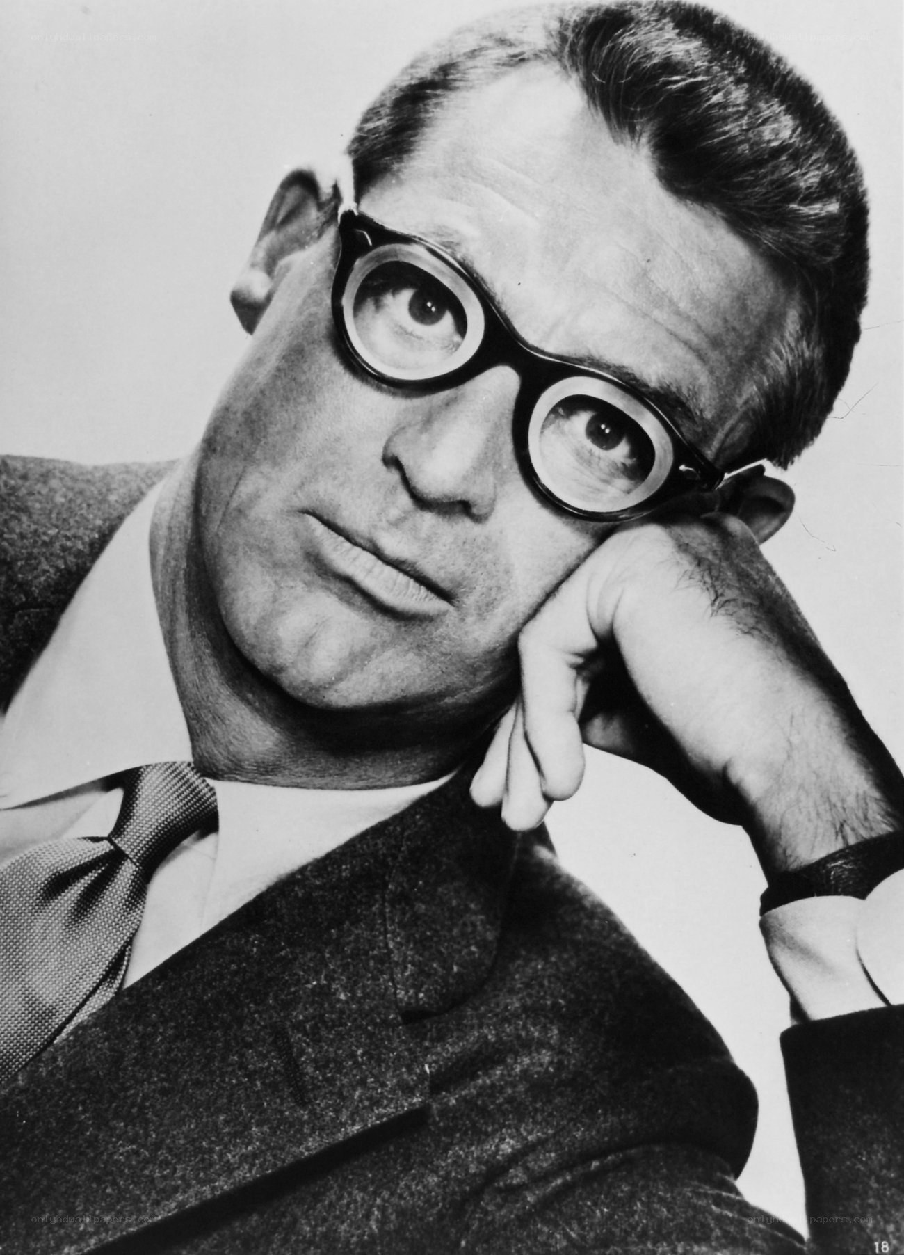 man in glasses resting head