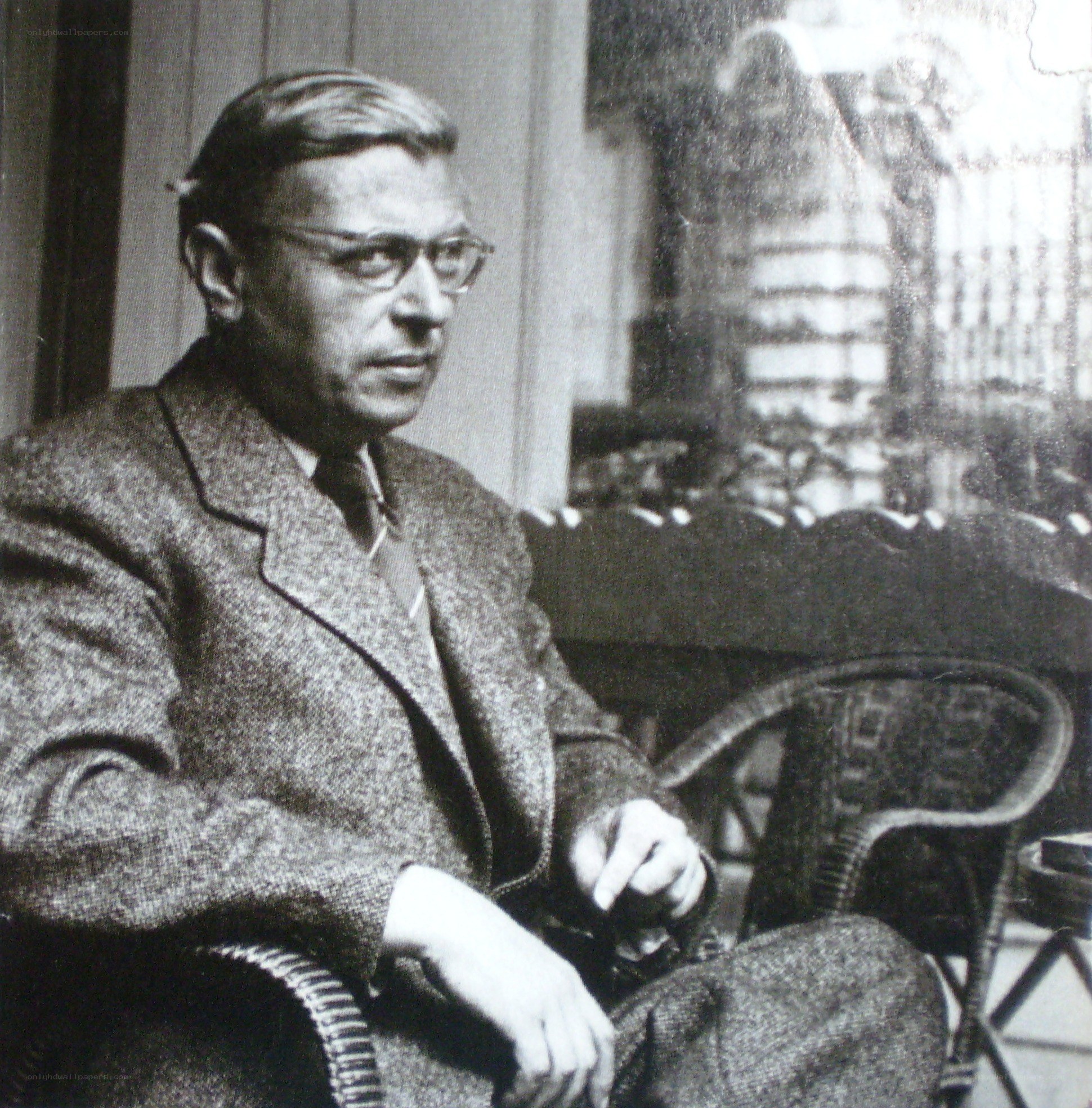 Man in glasses sitting in chair