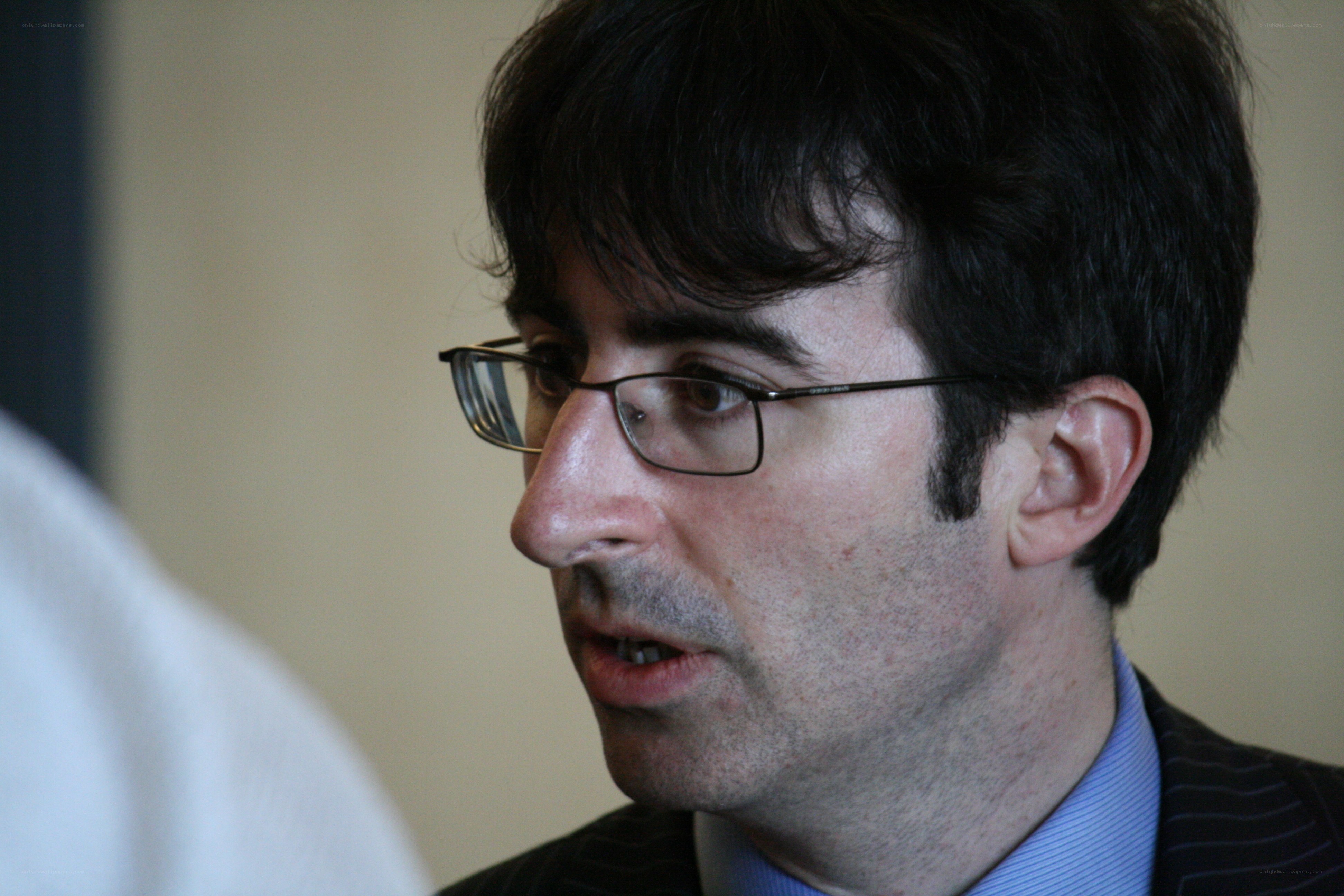 man in glasses speaking