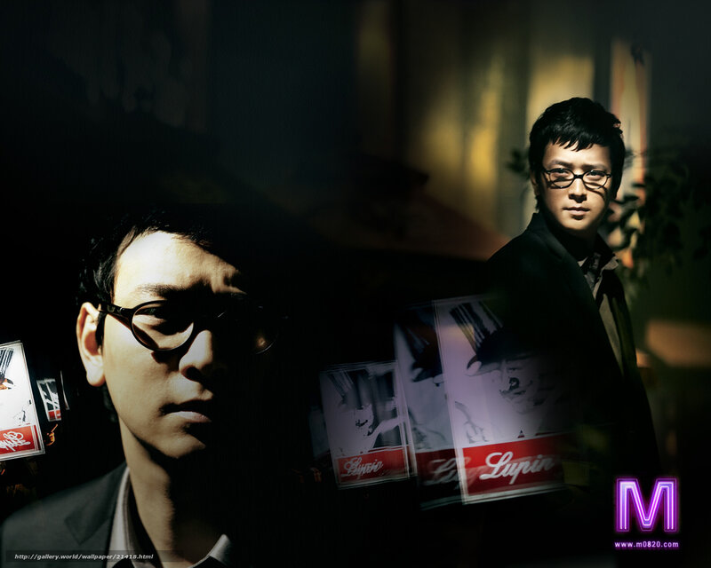 man in glasses with posters