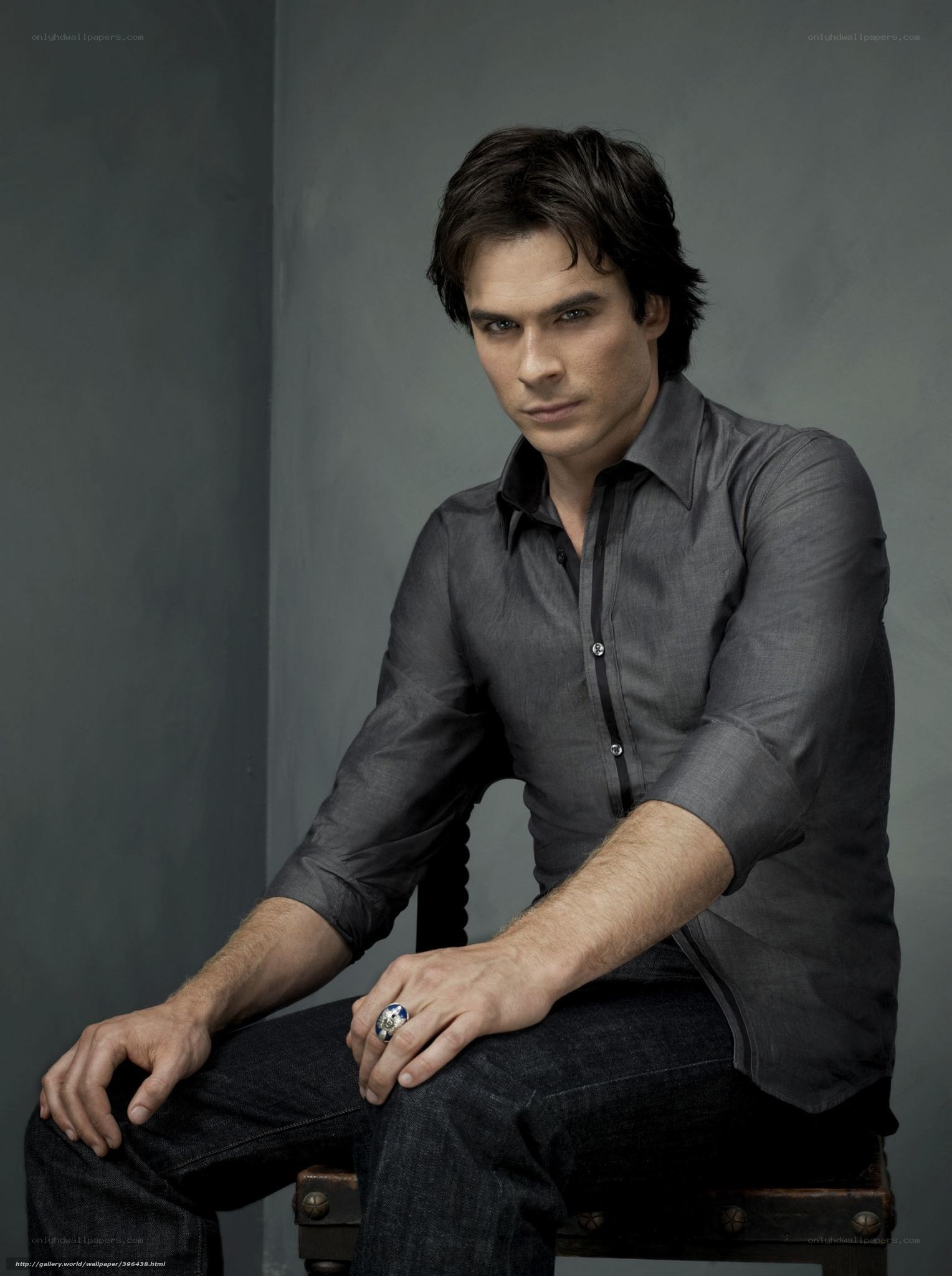 man in gray shirt sitting