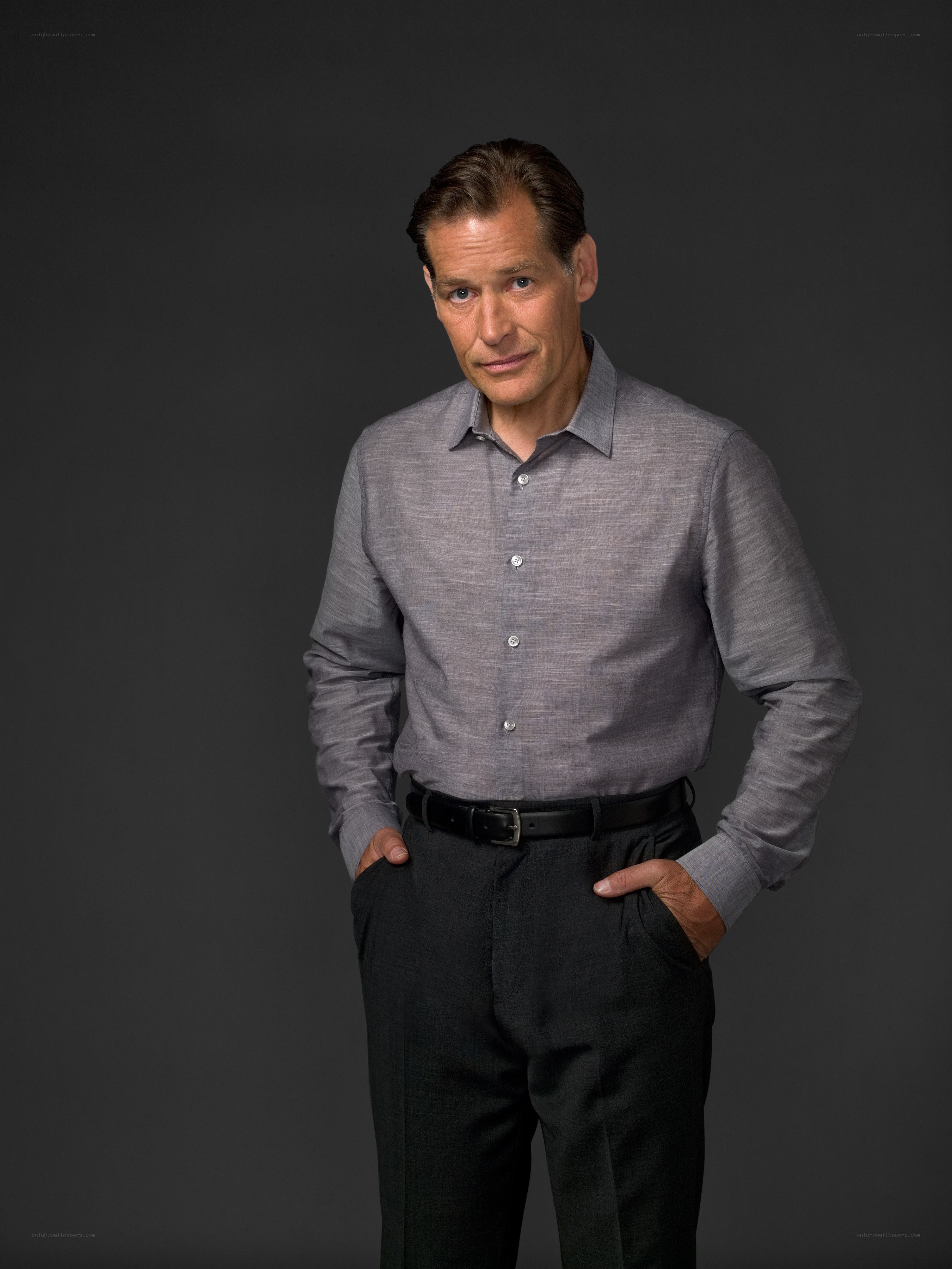 man in gray shirt standing