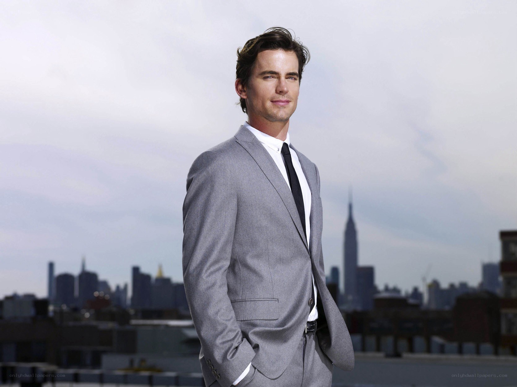 man in gray suit on rooftop