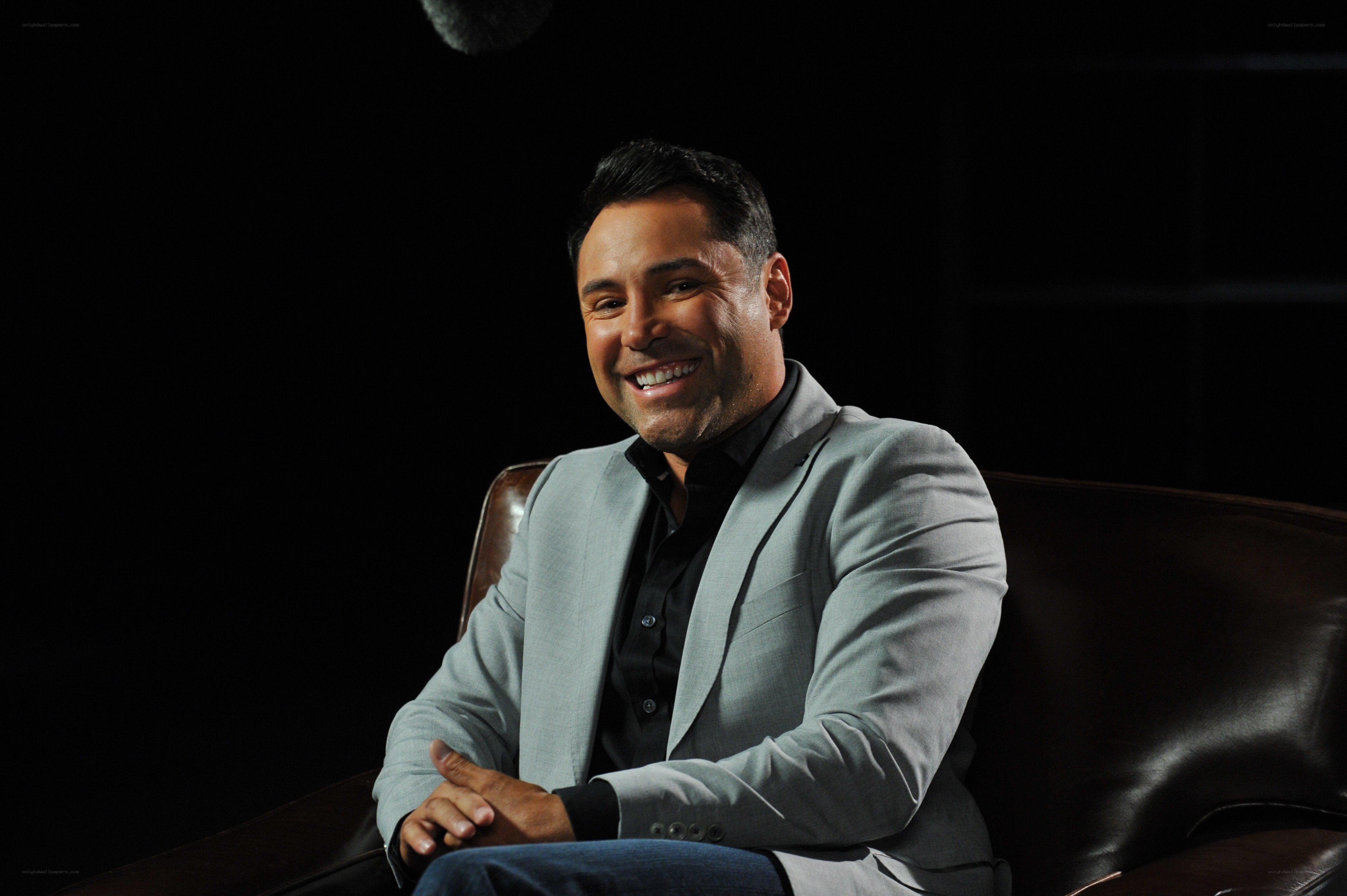 man in gray suit smiling