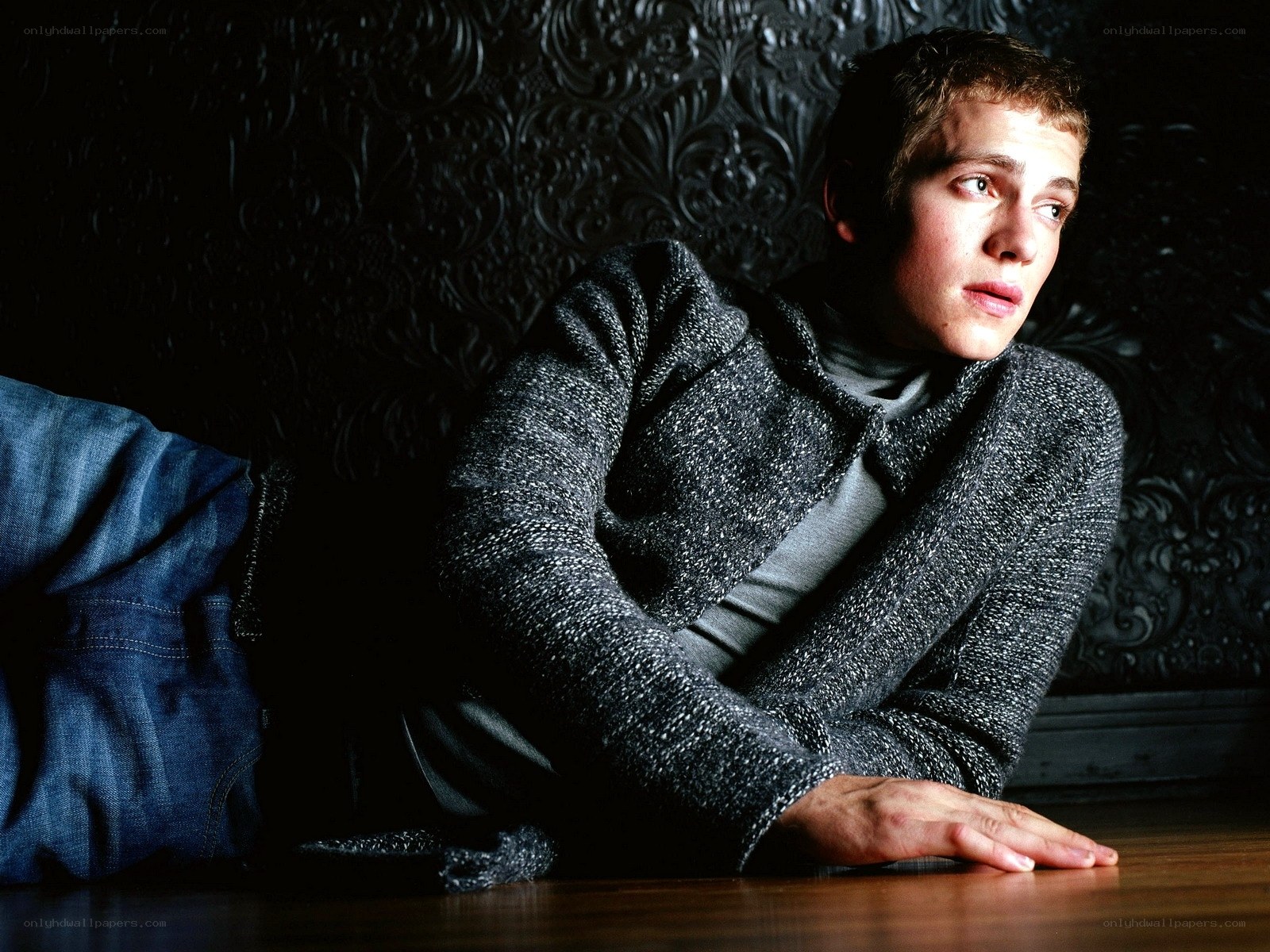 man in gray sweater lying down