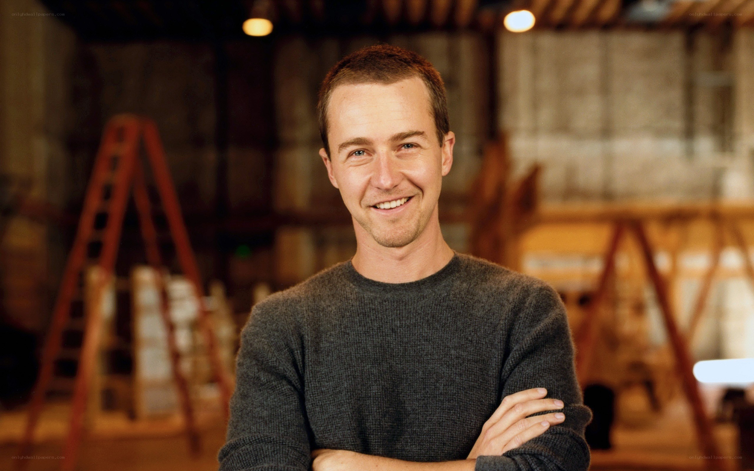 man in gray sweater smiling