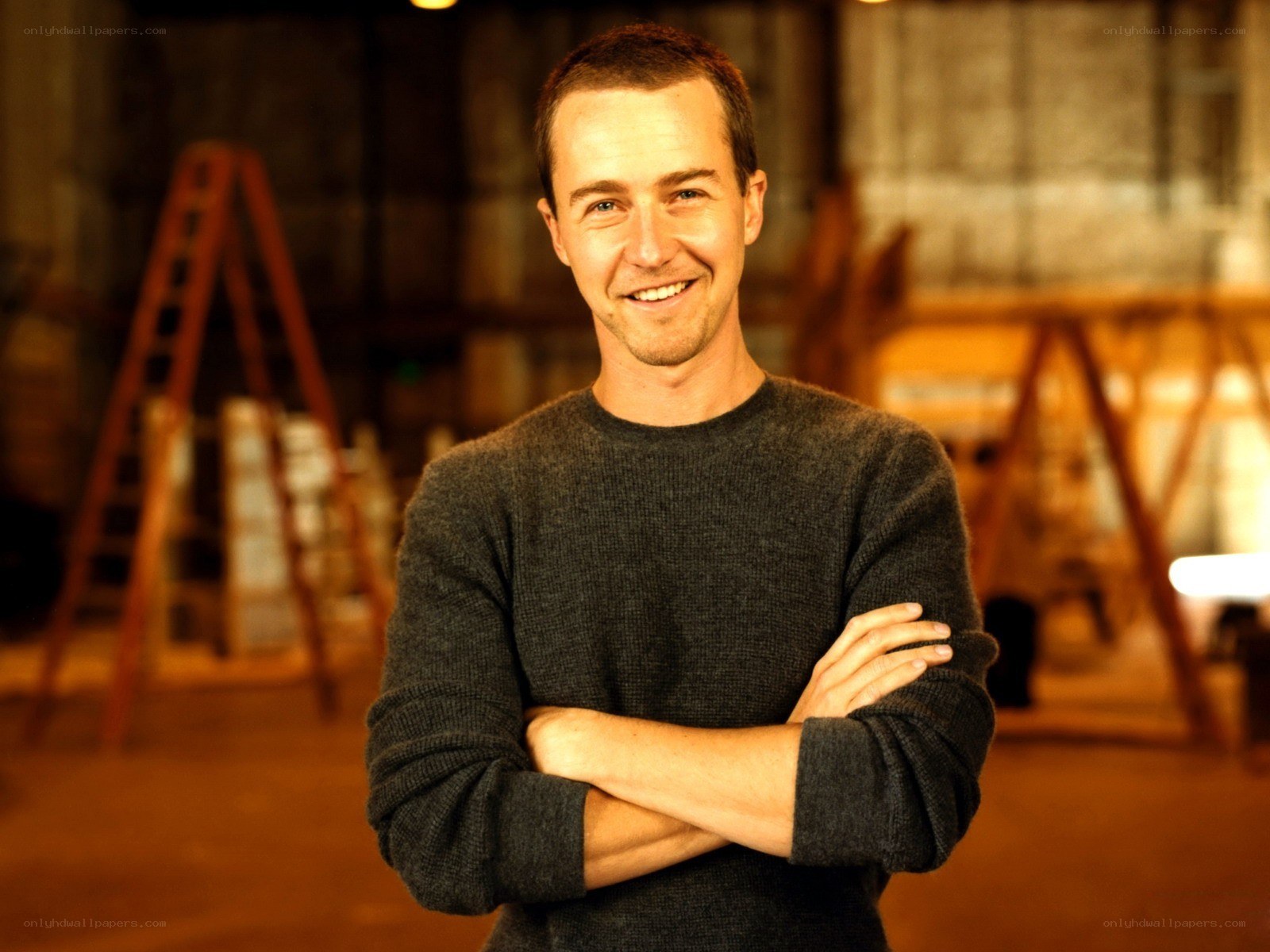 man in gray sweater smiling