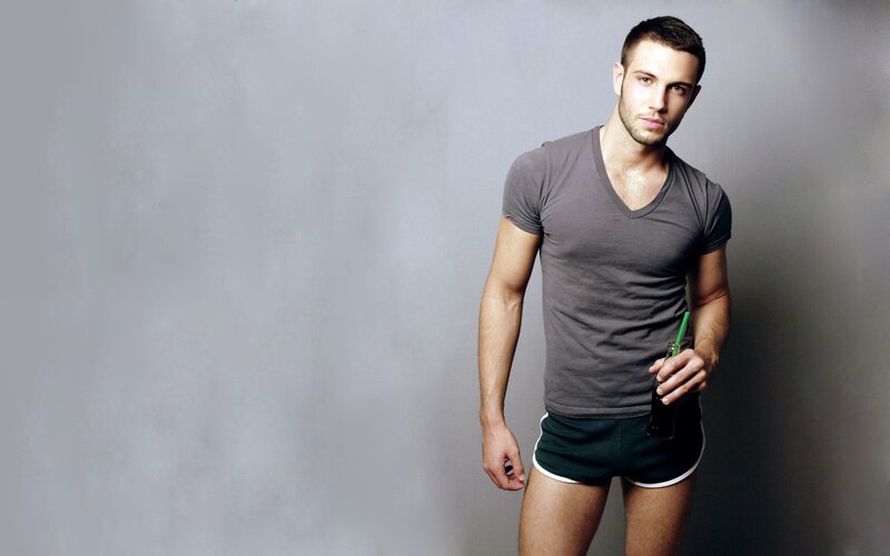 man in gray t-shirt holding drink