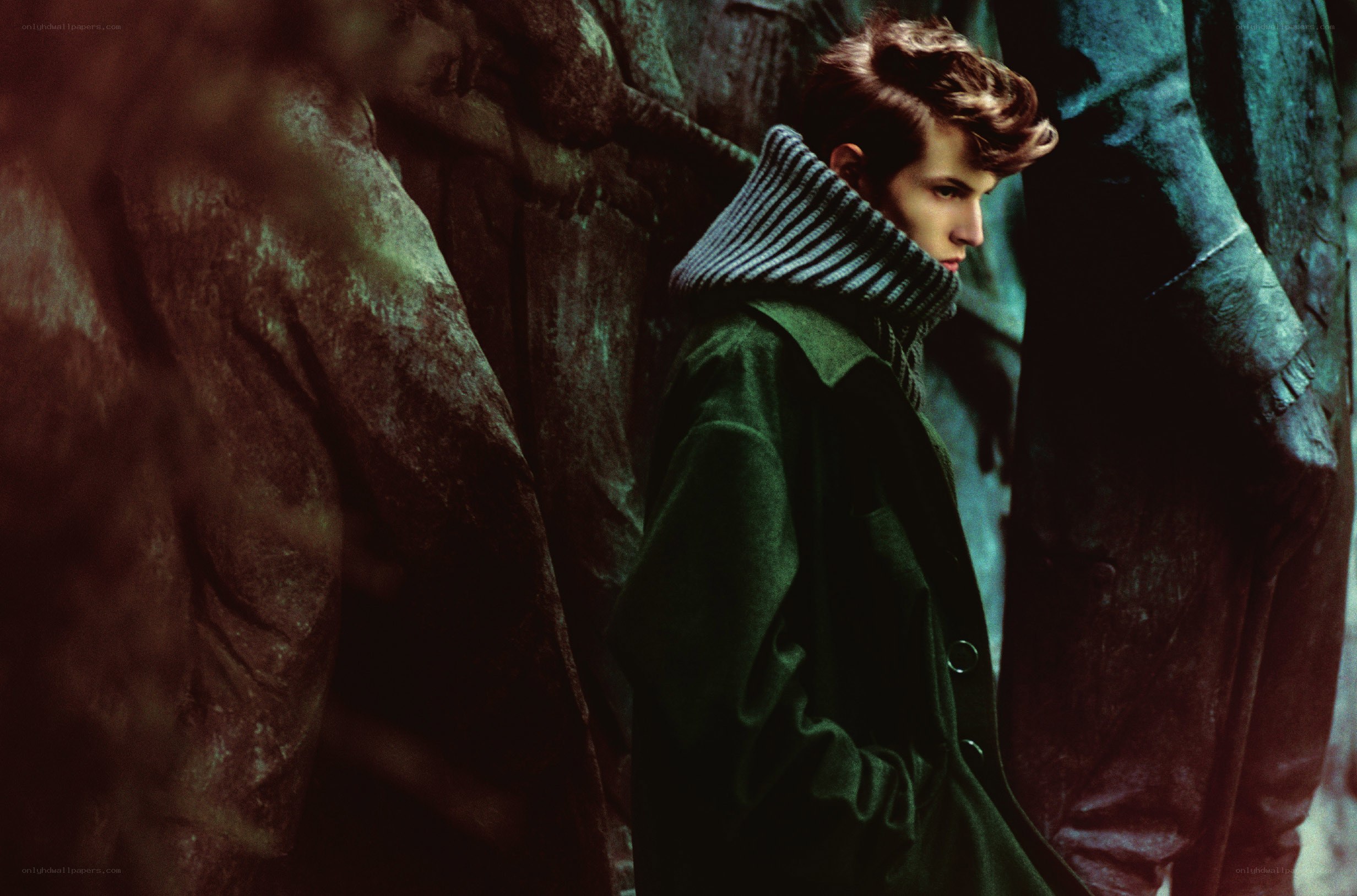 man in green coat standing