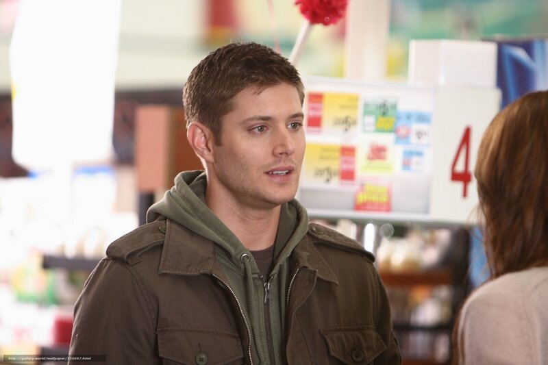 man in green jacket talking