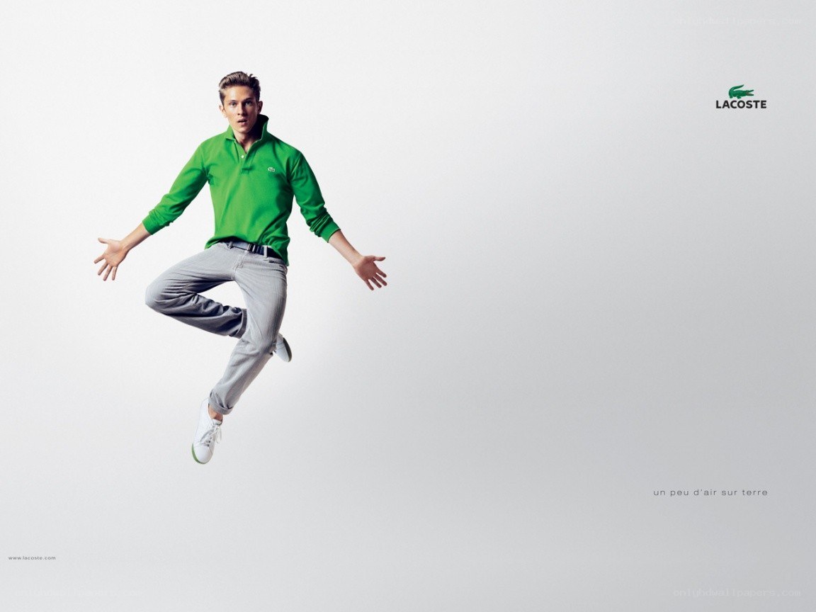Man in green polo jumping