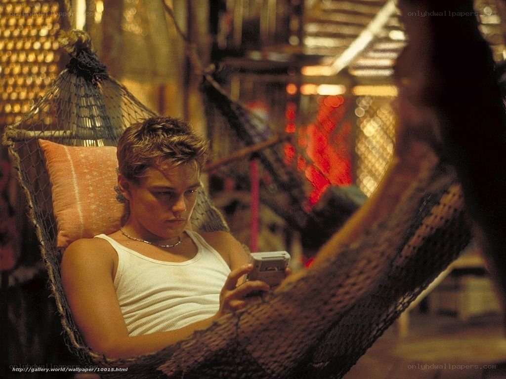 man in hammock with phone