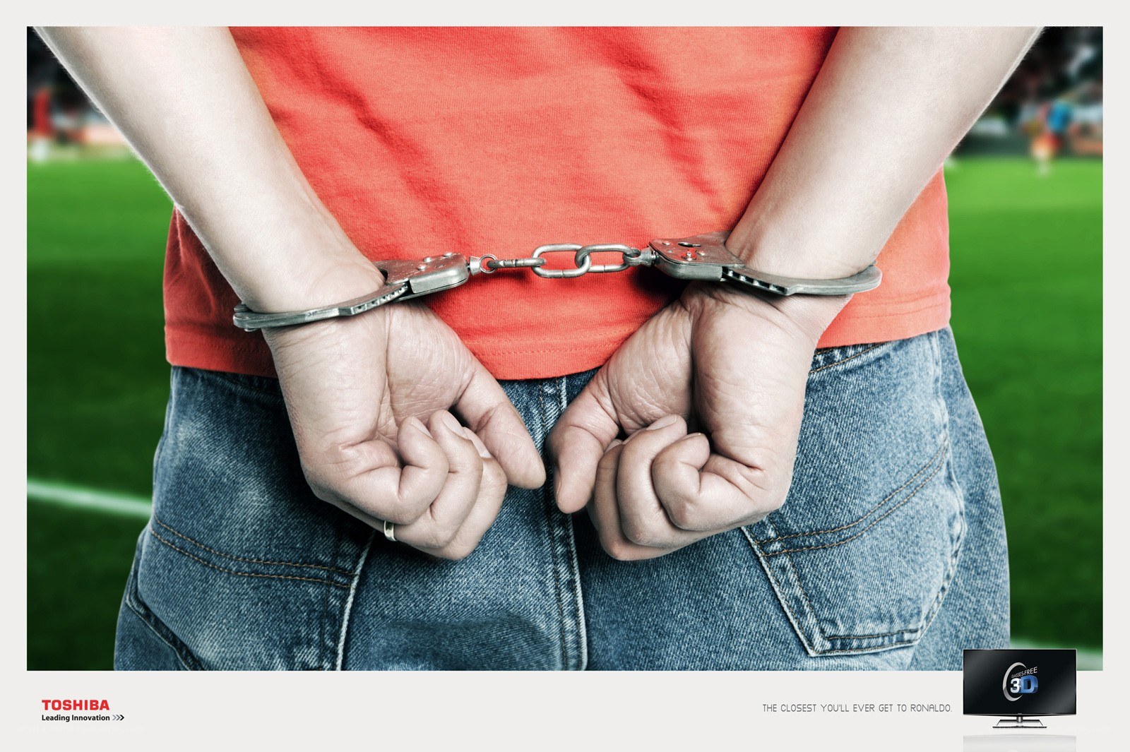 Man in handcuffs on soccer field