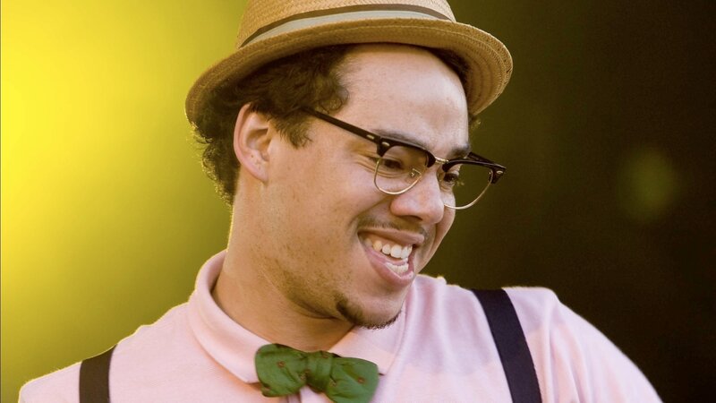 man in hat and bow tie smiling
