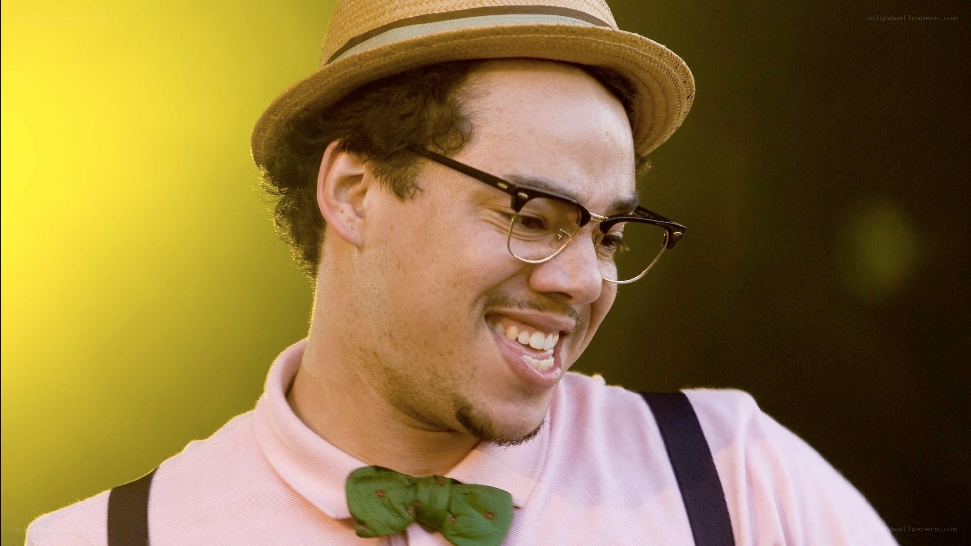 man in hat and bow tie smiling