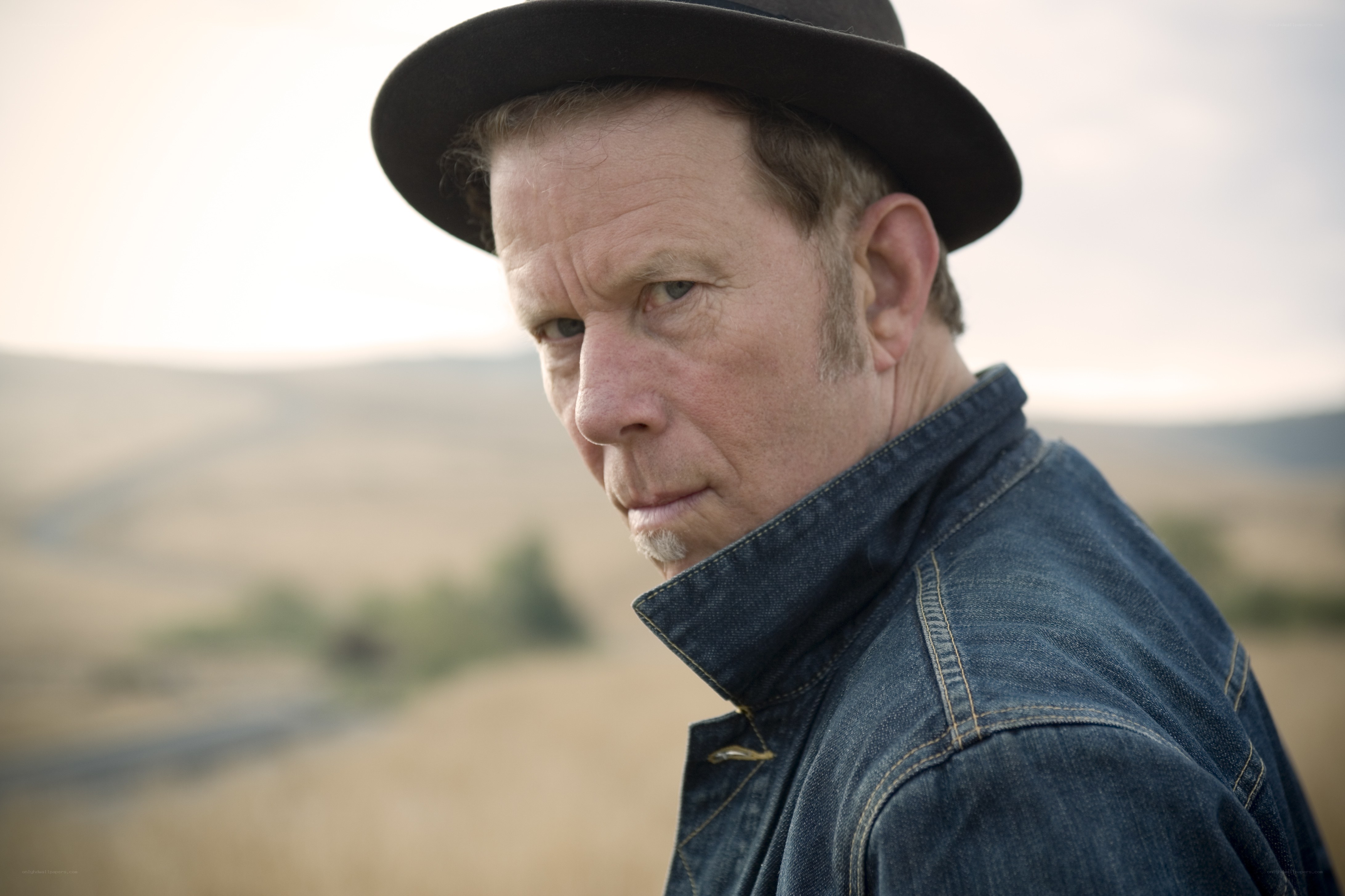 man in hat and denim jacket