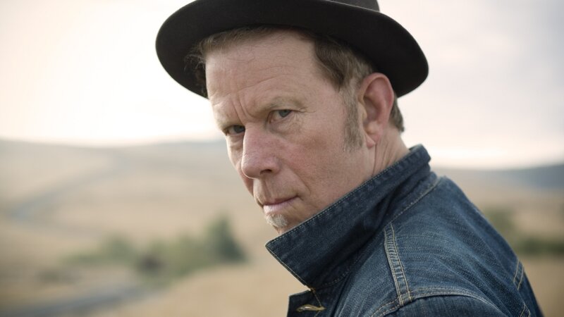 man in hat and denim jacket