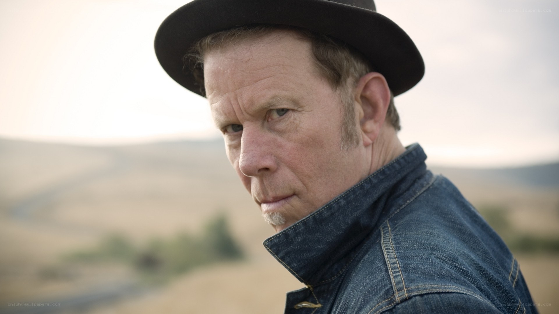 man in hat and denim jacket