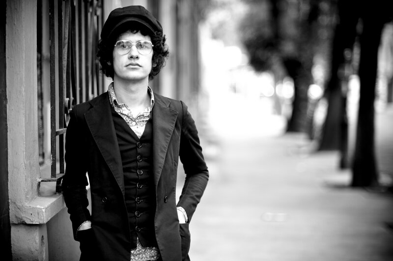 man in hat and glasses on street