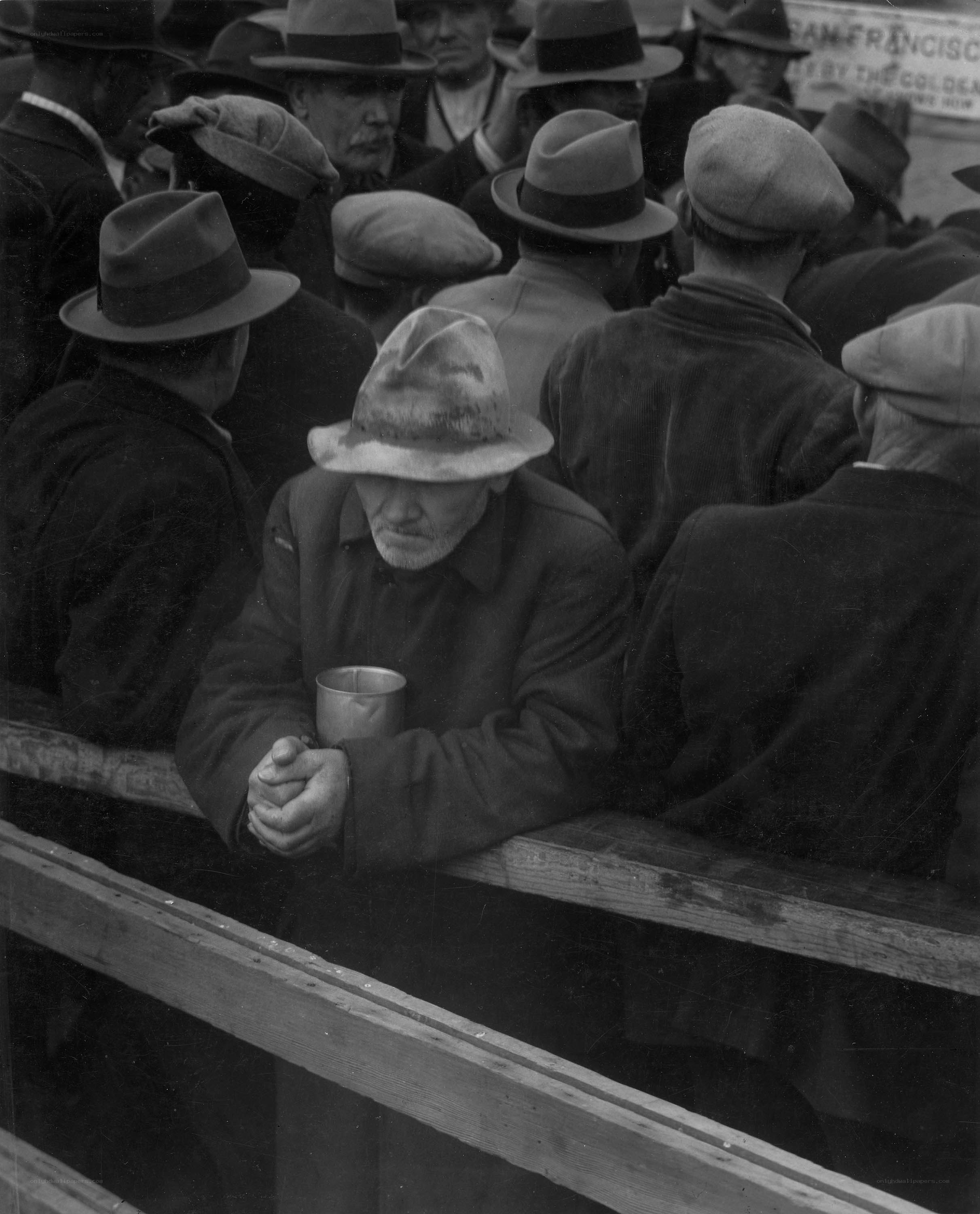 Man in hat holding cup