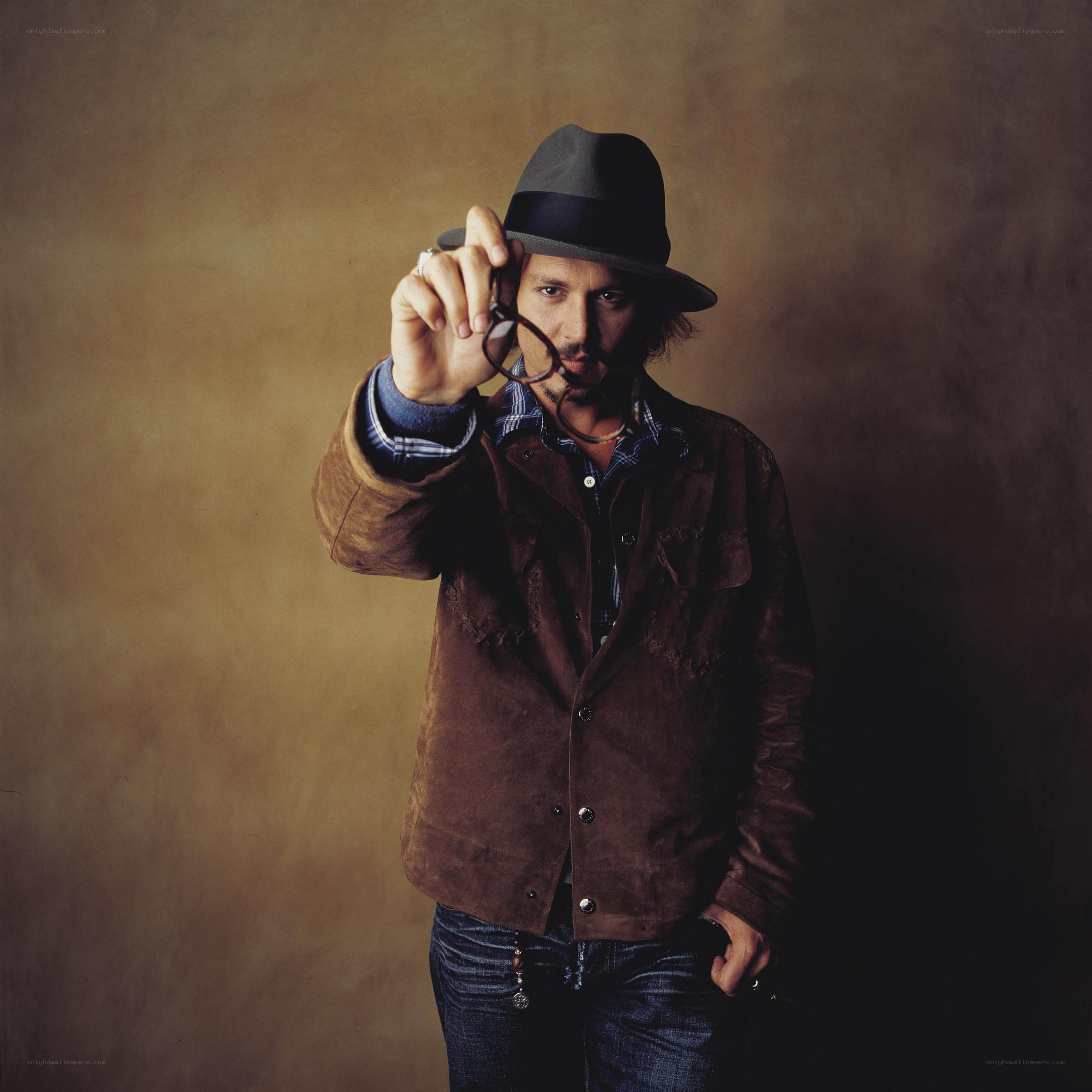 man in hat holding glasses